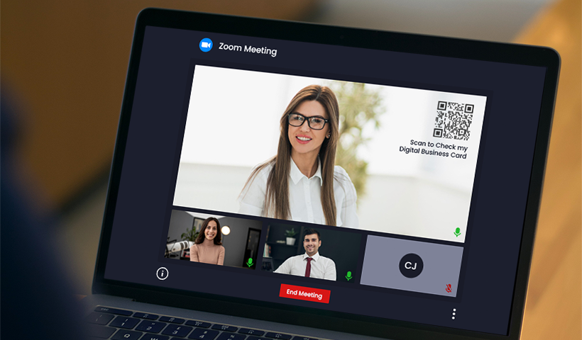 Laptop displaying a Zoom meeting with a woman presenting a QR code for her digital business card.